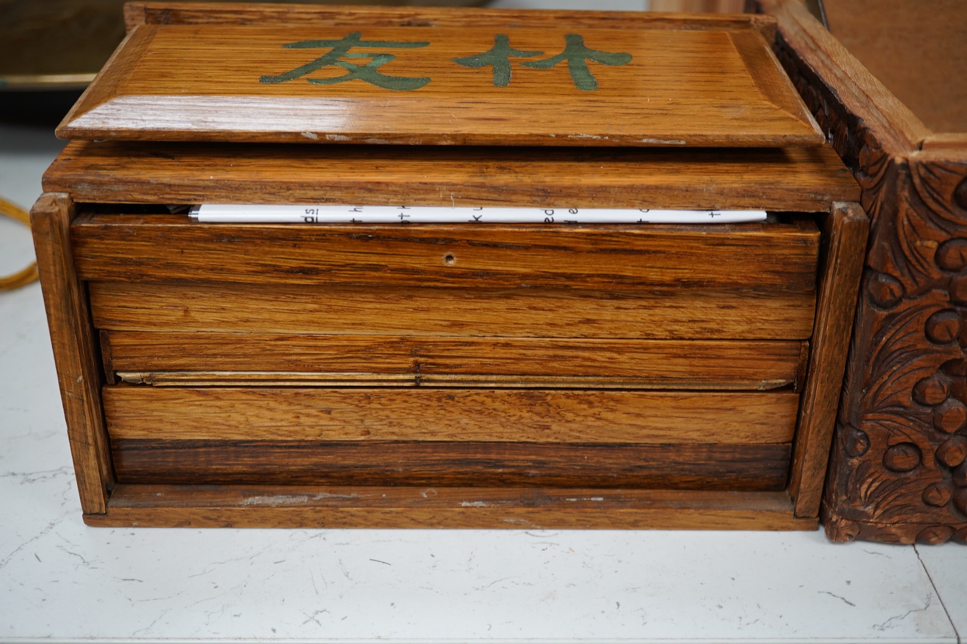 A Chinese carved small camphor box and an oak cased Mahjong set, camphor box 31cm wide x 17cm high. Condition - fair